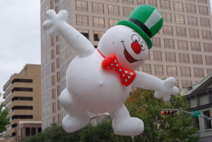 snowman shape helium parade balloon in the air.